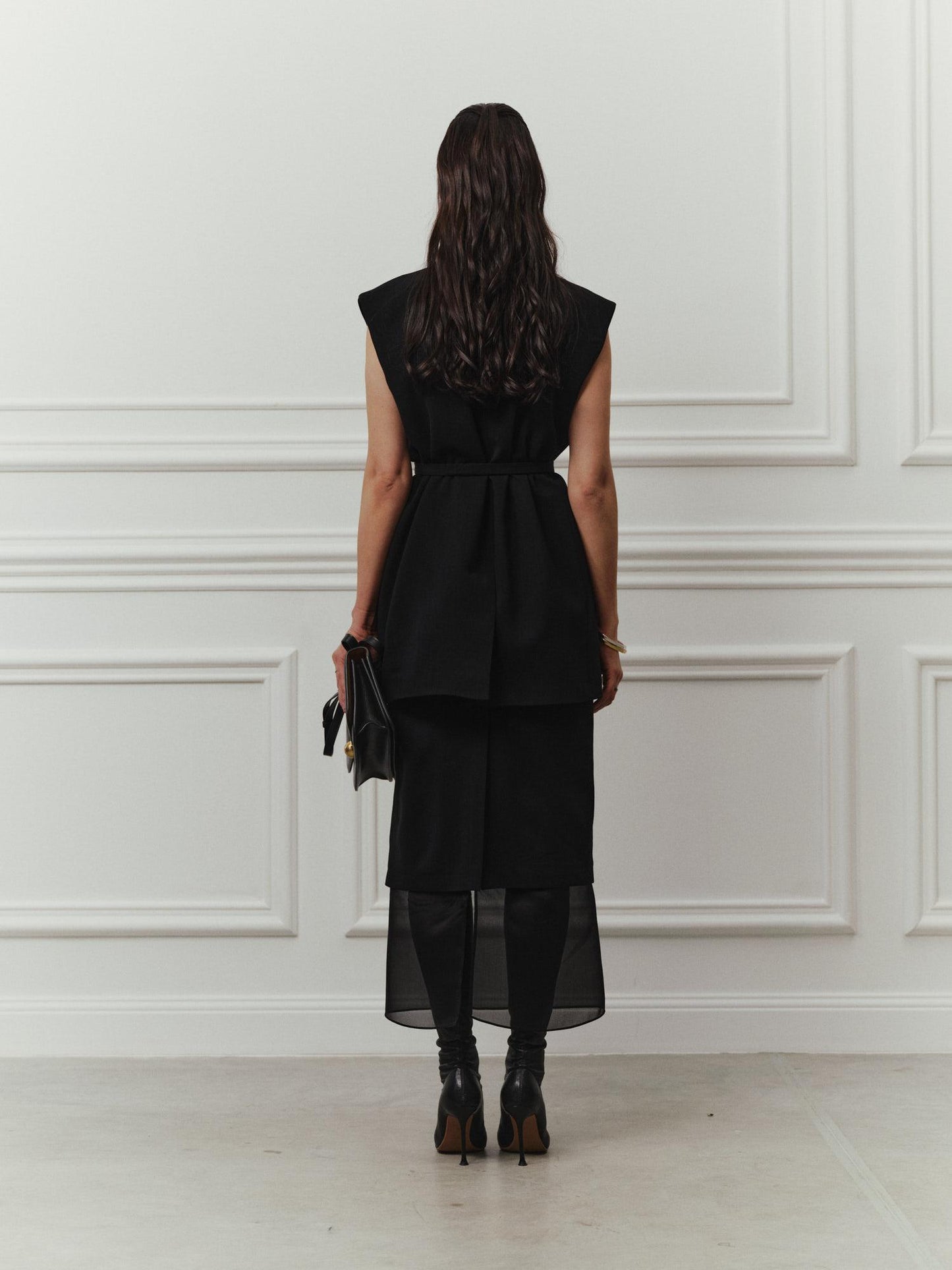 Tailored sleeveless jacket with accent silk lapels and belt