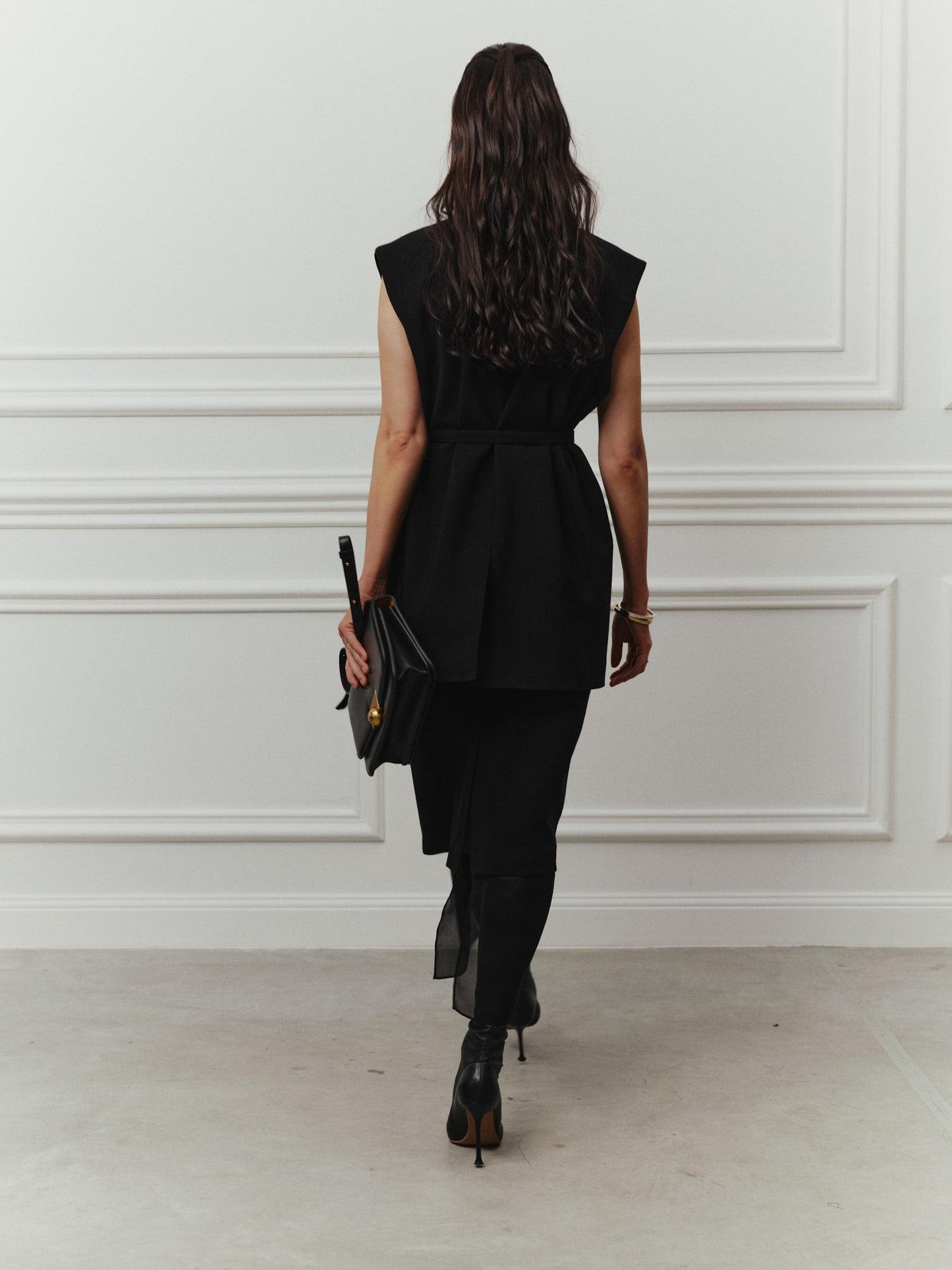 Tailored sleeveless jacket with accent silk lapels and belt