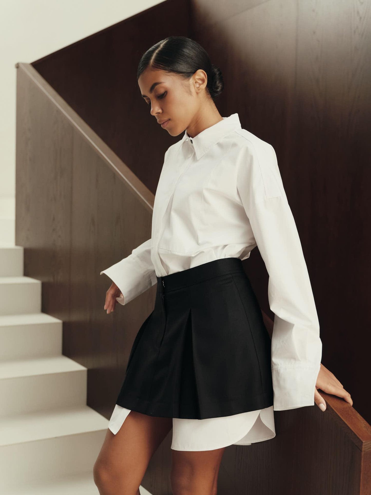 Pleated mini skirt in black structured wool