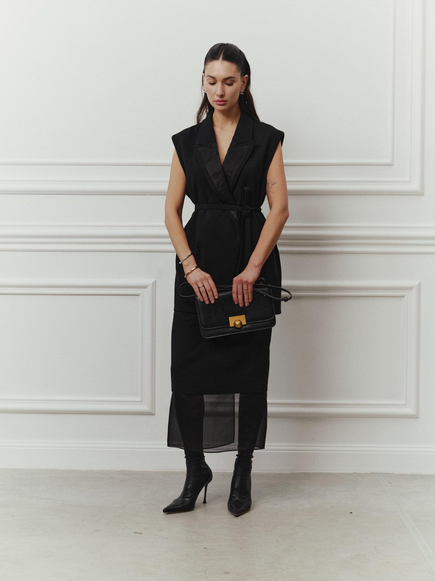 Tailored sleeveless jacket with accent silk lapels and belt