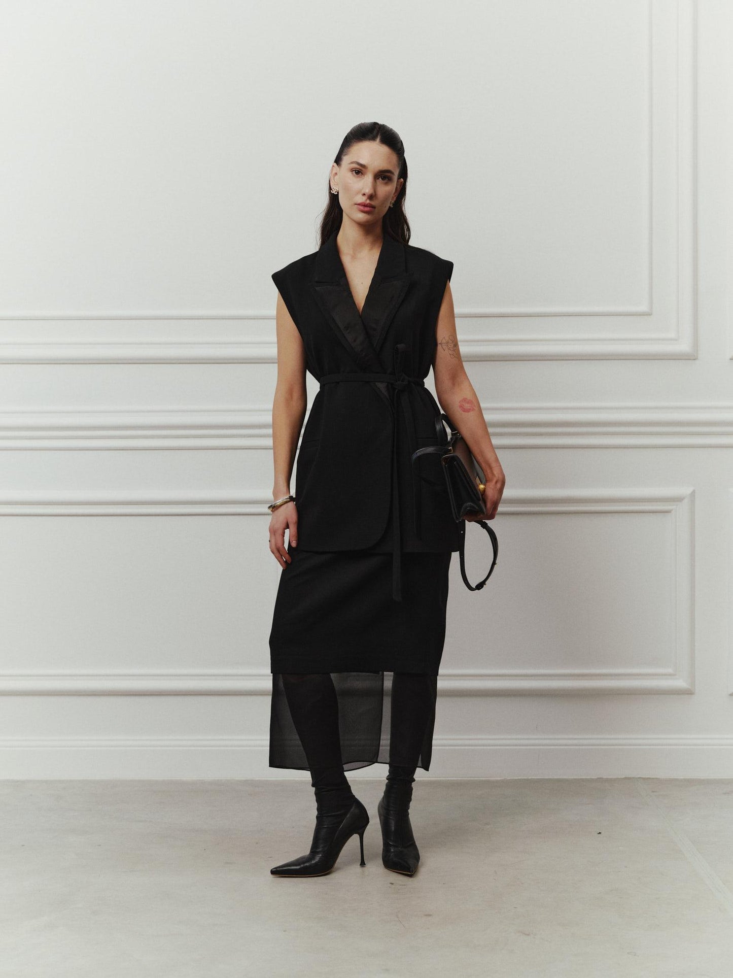 Tailored sleeveless jacket with accent silk lapels and belt