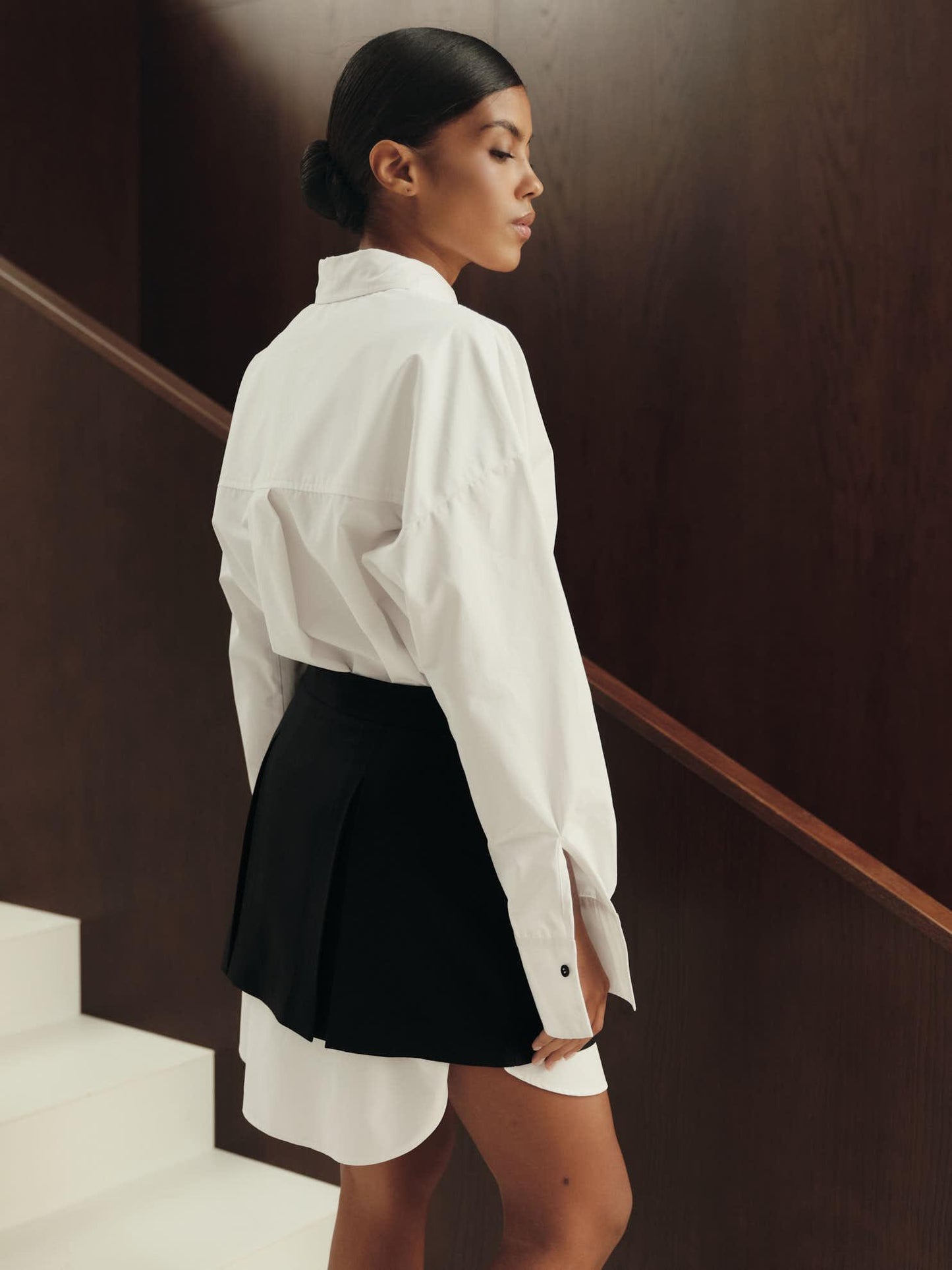 Pleated mini skirt in black structured wool