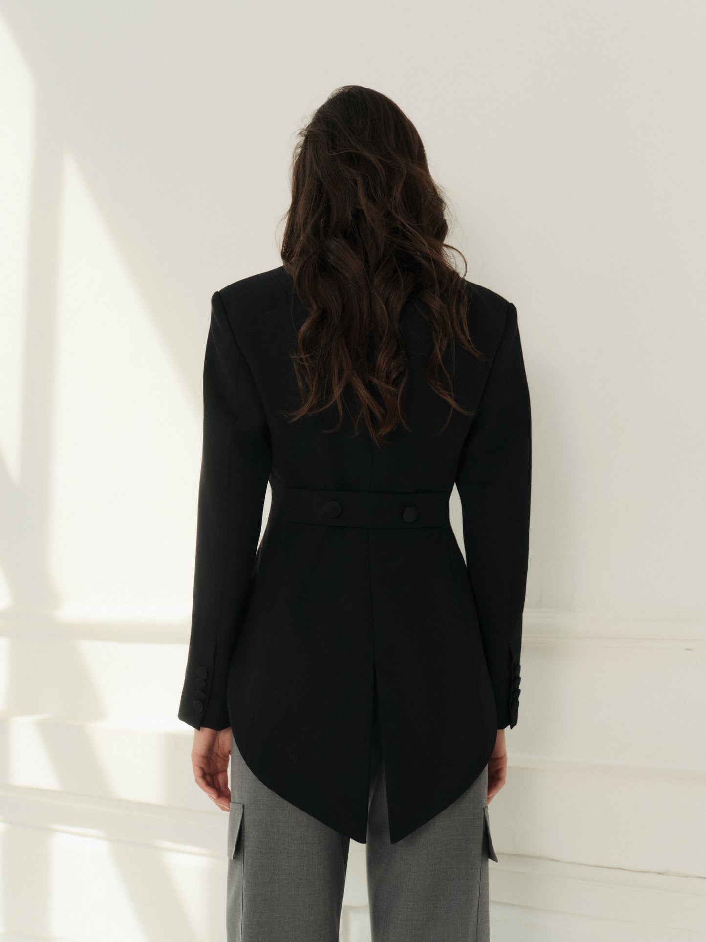 Cropped fitted tailcoat in black wool with accent satin lapels and lace cuffs