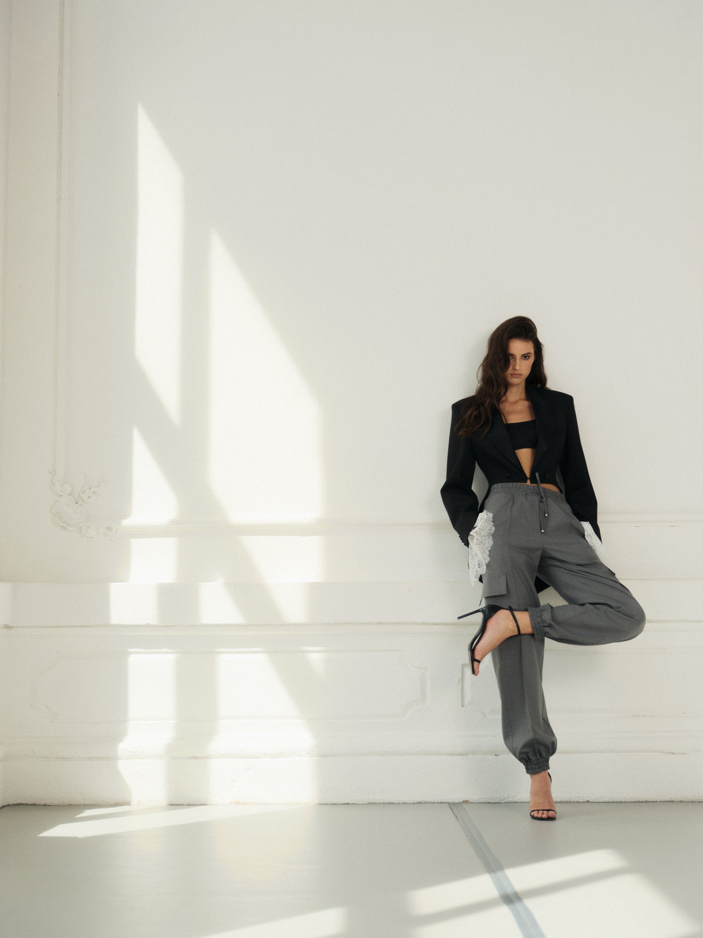 Cropped fitted tailcoat in black wool with accent satin lapels and lace cuffs