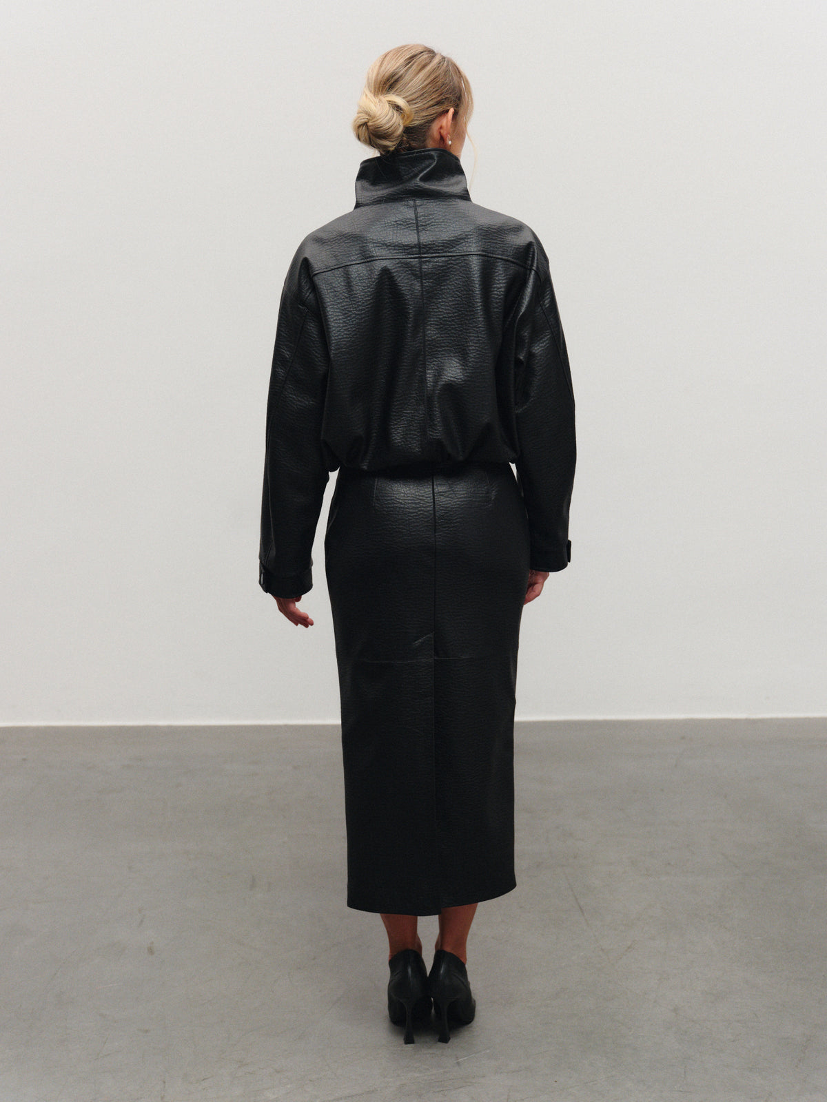 Vegan leather mid-length skirt with back slit