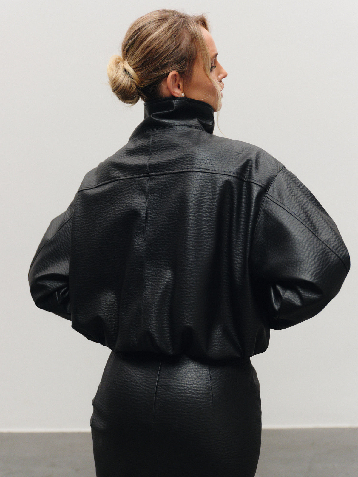 Insulated bomber jacket in black vegan leather