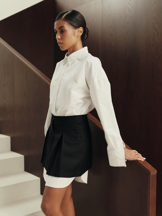 Pleated mini skirt in black structured wool