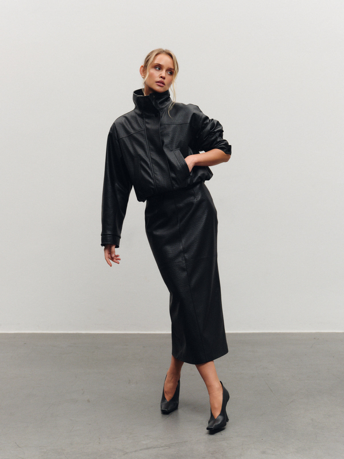 Vegan leather mid-length skirt with back slit