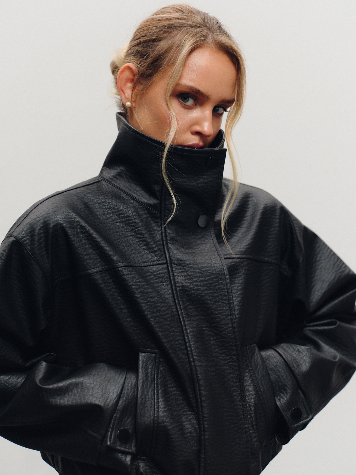 Insulated bomber jacket in black vegan leather