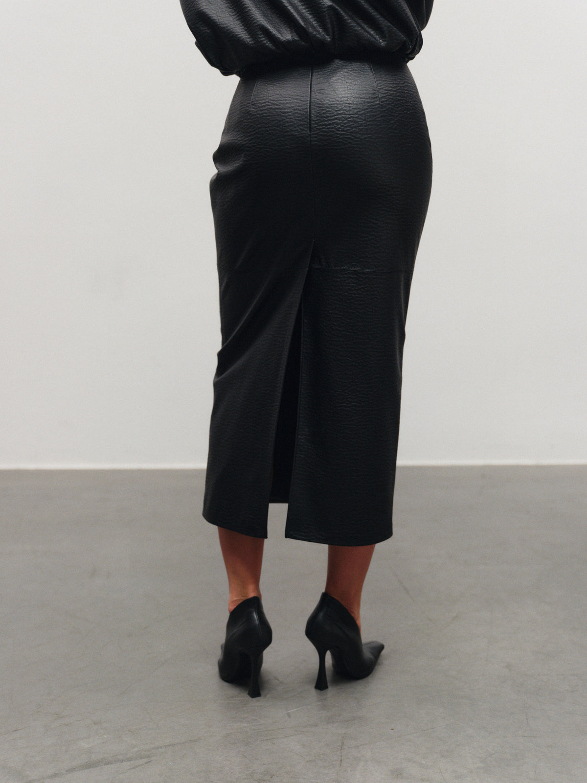 Vegan leather mid-length skirt with back slit